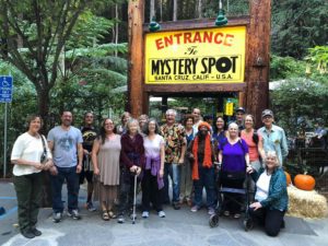 A group of people standing in front of a sign.