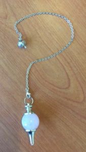 A necklace with a white stone on it